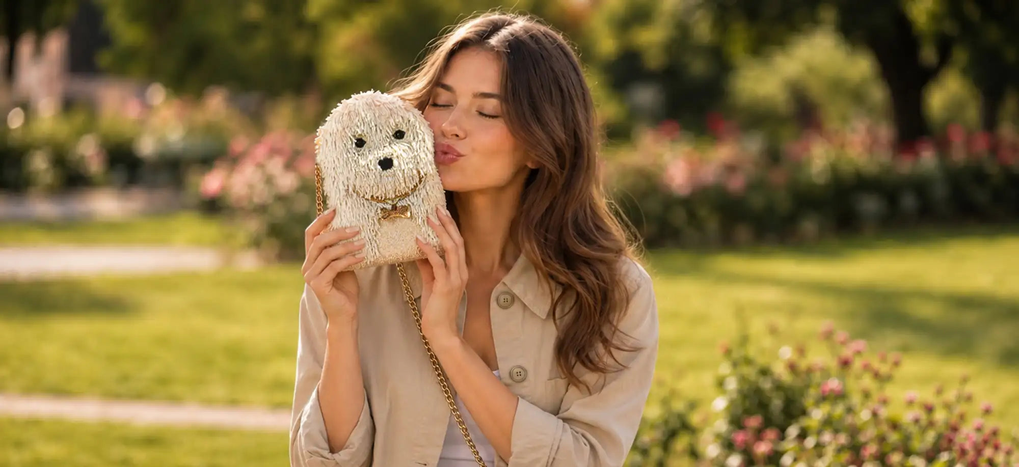 A cream-colored, beaded dog-shaped handbag with a gold chain strap.