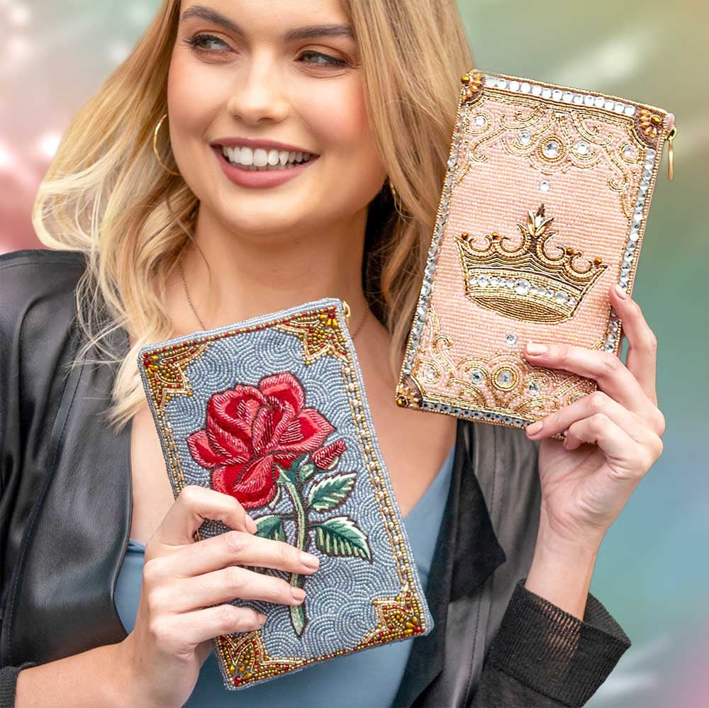 Model holding Crowned Jewel and Rose Petal Crossbody Phone Bags