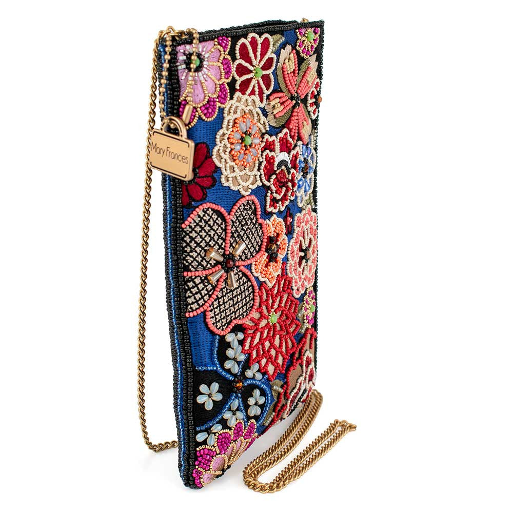 Ornate embroidered clutch purse with colorful floral designs and a gold chain strap.
