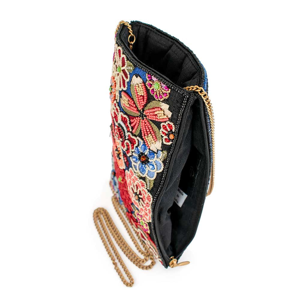 Embroidered floral clutch purse with a gold chain strap.