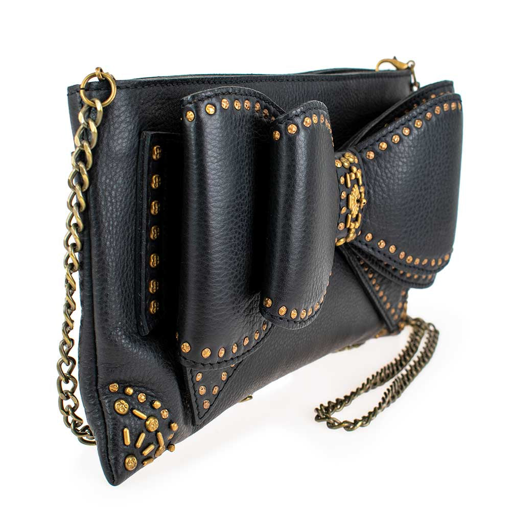 Black leather clutch purse with gold studded bow detail and chain strap.