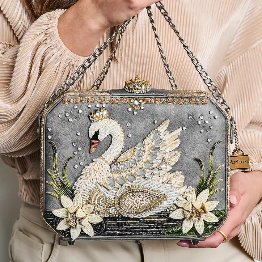 Embellished gray handbag with a beaded swan design.