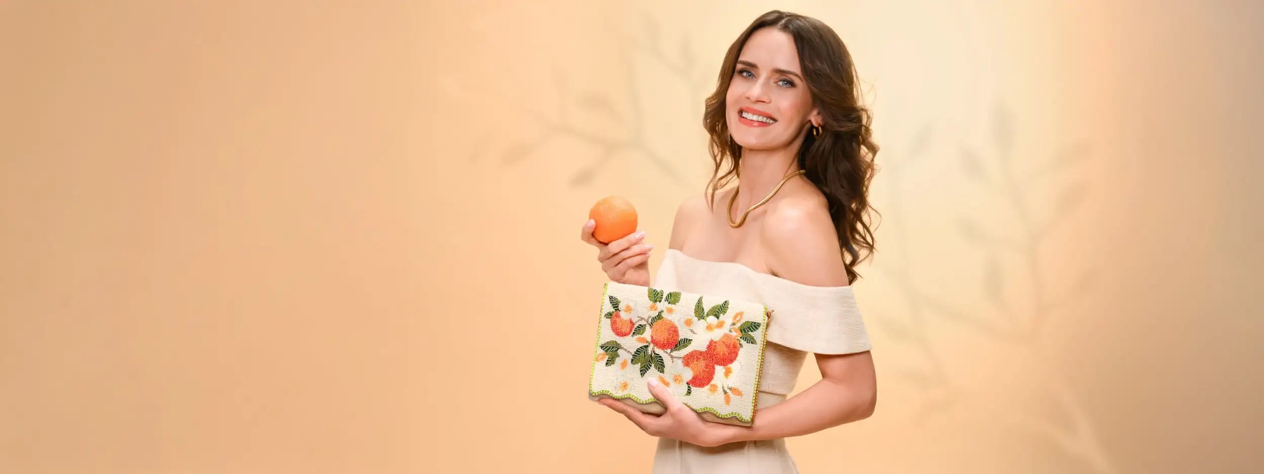 White clutch with embroidered orange and leaf pattern
