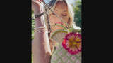 video model with pineapple island handbag